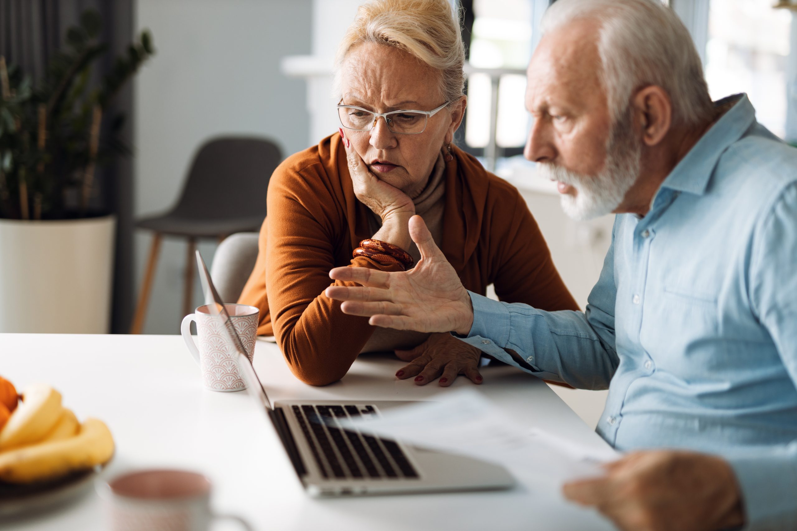 man and woman looking angry in front of a laptop